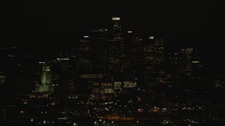 CAP_010_012 - HD stock footage aerial video of a view of the Downtown Los Angeles city skyline and city hall at night, California