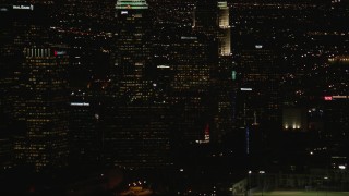 CAP_010_014 - HD stock footage aerial video tilt from Downtown Los Angeles city buildings to Figueroa and Wilshire skyscraper at night, California