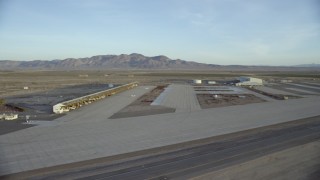 CAP_011_007 - HD stock footage aerial video pan across hangars at the Barstow-Daggett Airport in California at sunrise