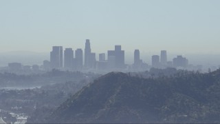 CAP_012_005 - HD stock footage aerial video of a view of the Downtown Los Angeles skyline, reveal Silver Lake Reservoir, California