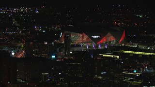 CAP_013_003 - HD stock footage aerial video of flying away from Mercedes Benz Stadium at night in Atlanta, Georgia