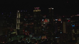 CAP_013_005 - HD stock footage aerial video of Mercedes Benz Stadium while flying by skyscrapers at night, Downtown Atlanta, Georgia