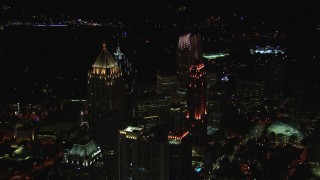 CAP_013_016 - HD stock footage aerial video approach skyscraper and hotel at night, Midtown Atlanta, Georgia