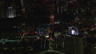 CAP_013_026 - HD stock footage aerial video of flying by city buildings and Ferris wheel at night, Downtown Atlanta, Georgia