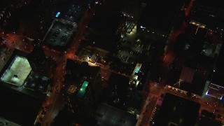 CAP_013_039 - HD stock footage aerial video tilt from AT&T Center to bird's eye of rooftop hotel pool and street at night, Midtown Atlanta, Georgia