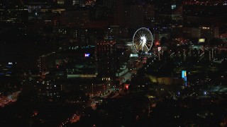 CAP_013_058 - HD stock footage aerial video of a condo complex and Ferris wheel at nighttime, Downtown Atlanta, Georgia