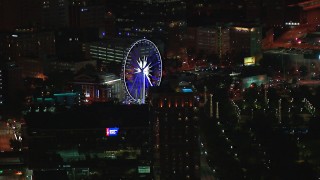 CAP_013_060 - HD stock footage aerial video of a Ferris wheel at nighttime, Downtown Atlanta, Georgia
