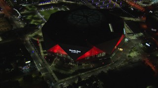 CAP_013_087 - HD stock footage aerial video of slowly flying toward and tilting to bird's eye of the stadium at night, Atlanta, Georgia