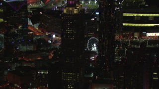 CAP_013_100 - HD stock footage aerial video of passing by skyscrapers to reveal the Ferris wheel at night, Downtown Atlanta, Georgia