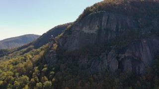 CAP_014_001 - 2.7K stock footage aerial video of a flag waving atop Chimney Rock in North Carolina