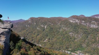 CAP_014_005 - 2.7K stock footage aerial video of flying by the rock formation to approach mountains at Chimney Rock in North Carolina
