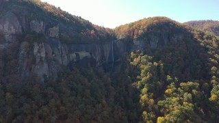 CAP_014_007 - 2.7K stock footage aerial video of ascend while focused on a waterfall at Chimney Rock, North Carolina