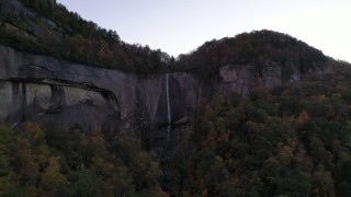 CAP_014_012 - 2.7K stock footage aerial video a clifftop waterfall at sunset, Chimney Rock, North Carolina