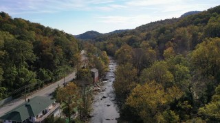 CAP_014_026 - 2.7K stock footage aerial video follow river over a bridge next to a road, Chimney Rock, North Carolina