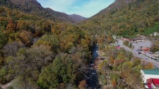 CAP_014_035 - 2.7K stock footage aerial video fly over a river by a small town road, Chimney Rock, North Carolina
