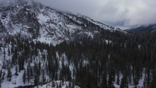 CAP_015_021 - 4K stock footage aerial video of snow-covered mountain slopes and evergreens, Inyo National Forest, California