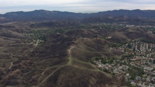 CAP_018_001 - HD stock footage aerial video of flying by suburban homes and burned hills in Malibu, California