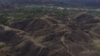 CAP_018_003 - HD stock footage aerial video of flying above burned hills in Malibu, California