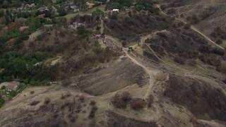 CAP_018_004 - HD stock footage aerial video of flying above burned hills toward destroyed homes in Malibu, California