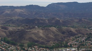 CAP_018_011 - HD stock footage aerial video of a wide view of hills scarred by fire, Malibu, California