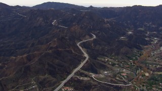 CAP_018_013 - HD stock footage aerial video of mountains and road scarred by fire, Malibu, California