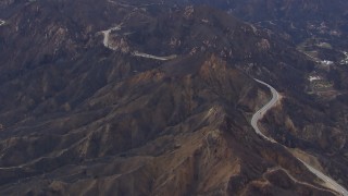 CAP_018_014 - HD stock footage aerial video of flying by road by mountains scarred by fire, Malibu, California