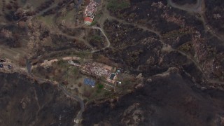 CAP_018_023 - HD stock footage aerial video of a bird's eye view of hillside homes destroyed by fire, Malibu, California