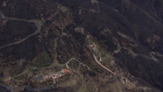 CAP_018_025 - HD stock footage aerial video fly away from and orbit hillside homes destroyed by fire, Malibu, California
