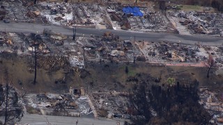CAP_018_033 - HD stock footage aerial video pan across homes in a neighborhood destroyed by fire, Malibu, California
