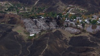 CAP_018_037 - HD stock footage aerial video of flying away from ruins in a neighborhood devastated by fire, Malibu, California