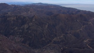 CAP_018_039 - HD stock footage aerial video of flying over mountains scorched by fire, Malibu, California