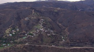 CAP_018_048 - HD stock footage aerial video of a reverse view of homes destroyed by fire, Malibu, California