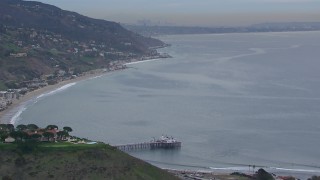 CAP_018_052 - HD stock footage aerial video of flying toward and tilting to Malibu Pier at sunset, California