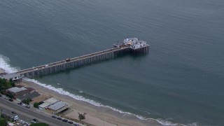 CAP_018_053 - HD stock footage aerial video of approaching and orbiting Malibu Pier at sunset, California