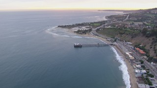 CAP_018_055 - HD stock footage aerial video of flying away from Malibu Pier at sunset, California
