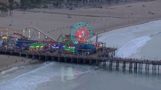 CAP_018_070 - HD stock footage aerial video of the Ferris wheel at Santa Monica Pier at sunset, California