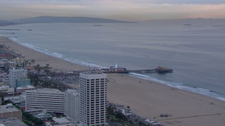 CAP_018_072 - HD stock footage aerial video fly away from and orbit Santa Monica Pier at sunset, California