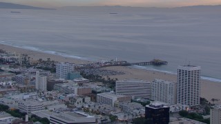 CAP_018_073 - HD stock footage aerial video of a wider orbit of Santa Monica Pier at sunset, California