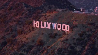 CAP_018_083 - HD stock footage aerial video of orbiting the famous Hollywood Sign at sunset, California