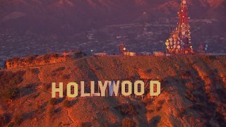 CAP_018_085 - HD stock footage aerial video of flying away from the famous Hollywood Sign at sunset, California