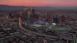 CAP_018_099 - HD stock footage aerial video of Downtown Los Angeles skyscrapers, arena and convention center at sunset, California