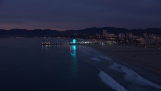 CAP_018_106 - HD stock footage aerial video of slowly approaching Santa Monica Pier at twilight, California