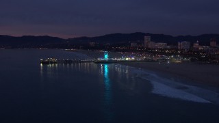 CAP_018_107 - HD stock footage aerial video of approaching Santa Monica Pier and Ferris wheel at twilight, California