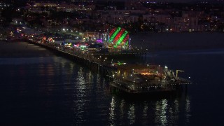 CAP_018_110 - HD stock footage aerial video of flying toward the end of Santa Monica Pier and Ferris wheel at twilight, California