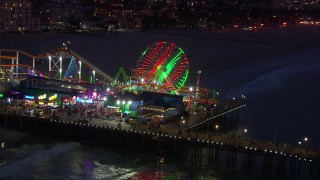 CAP_018_111 - HD stock footage aerial video orbit and fly away from Ferris wheel at twilight, Santa Monica Pier, California