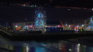 CAP_018_113 - HD stock footage aerial video of the Ferris wheel and rides at night, Santa Monica Pier, California