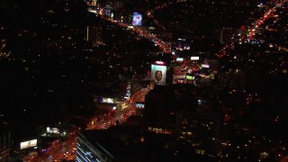 CAP_018_126 - HD stock footage aerial video approach billboard by the Sunset Strip at night in West Hollywood, California