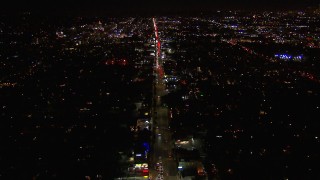 CAP_018_135 - HD stock footage aerial video of tilting for a wide view of Sunset Blvd at night through Hollywood, California