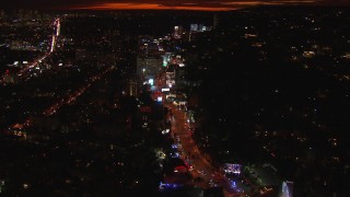 CAP_018_138 - HD stock footage aerial video flying toward Sunset Strip, billboards and traffic at night in West Hollywood, California