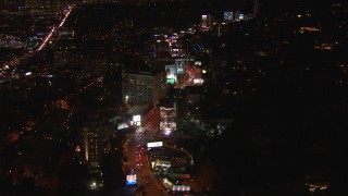 CAP_018_139 - HD stock footage aerial video flying over Sunset Strip, billboards and traffic at night in West Hollywood, California